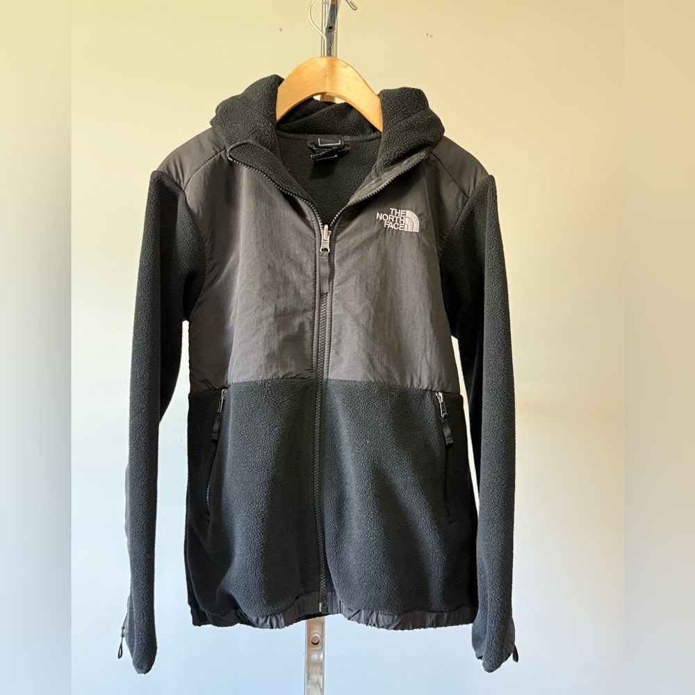 The North Face…High-neck fleece jacket with a hood and zippered front pockets. L